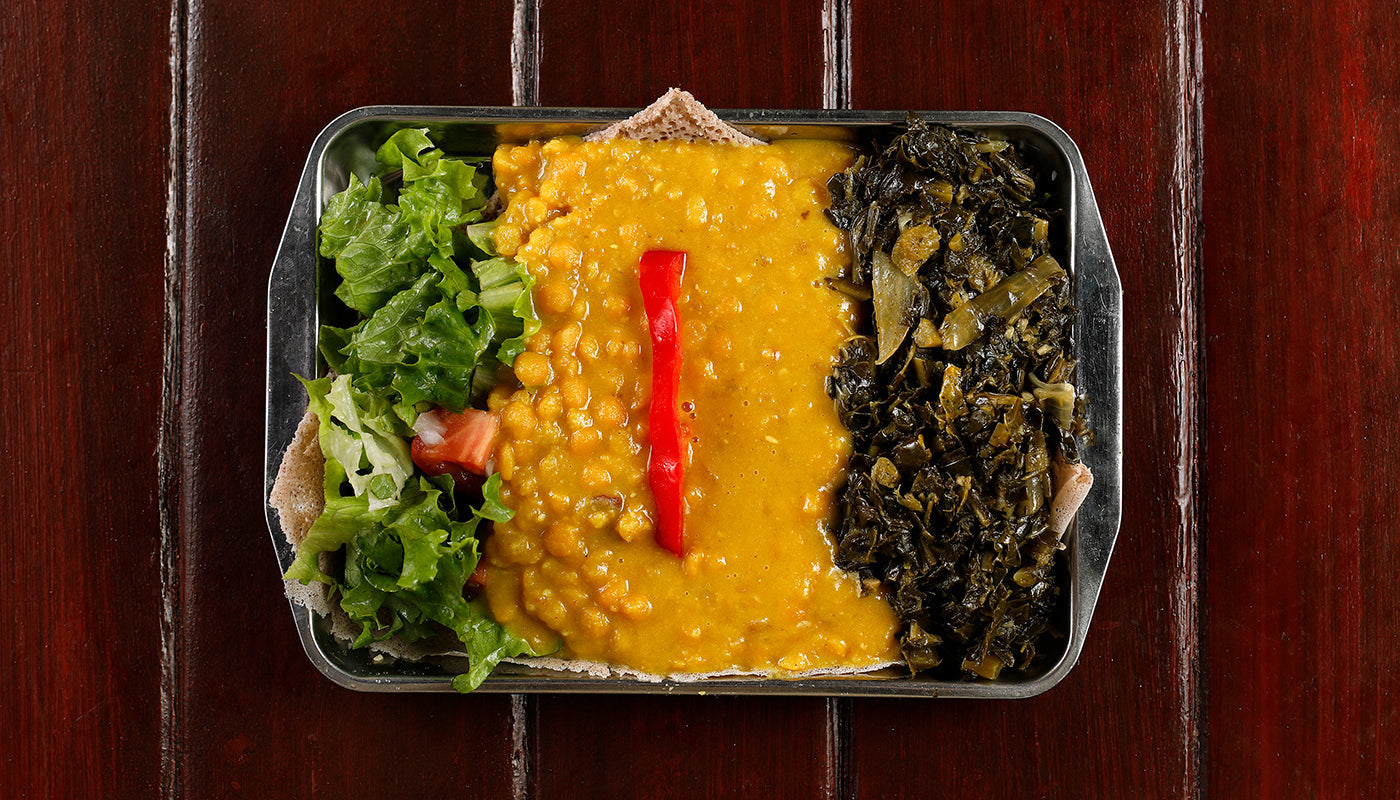 Kik Alicha (Mild Ird Split Pea Lentils), served with gomen over injera