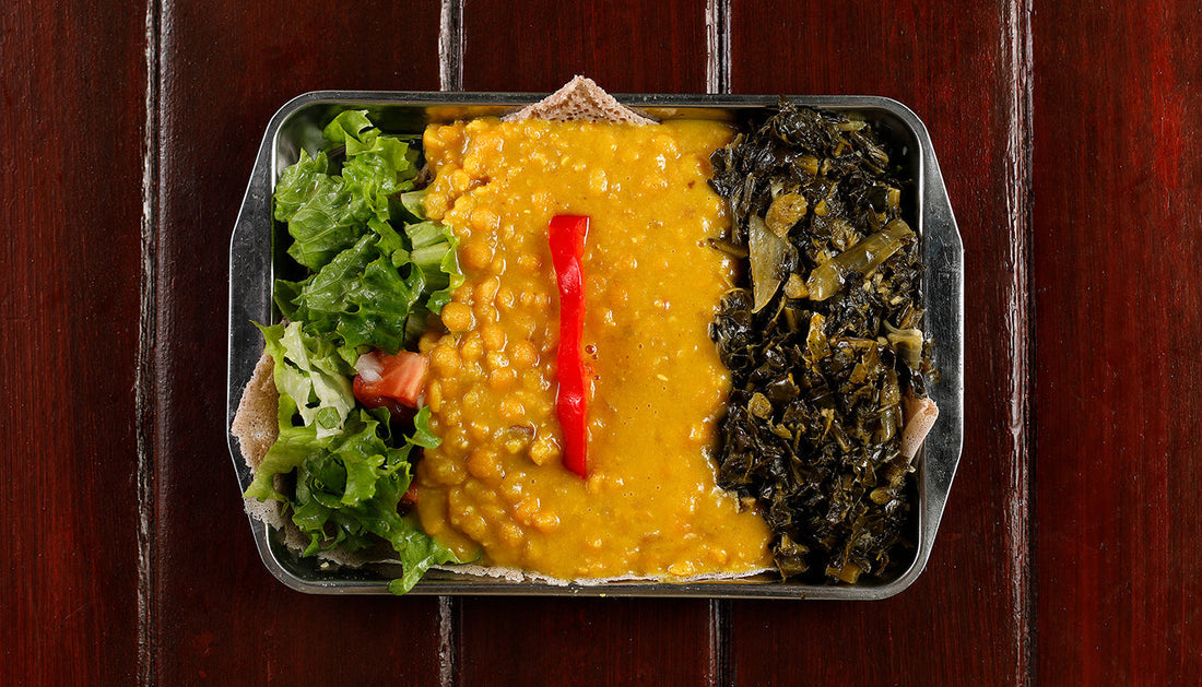 Kik Alicha (Mild Ird Split Pea Lentils), served with gomen over injera