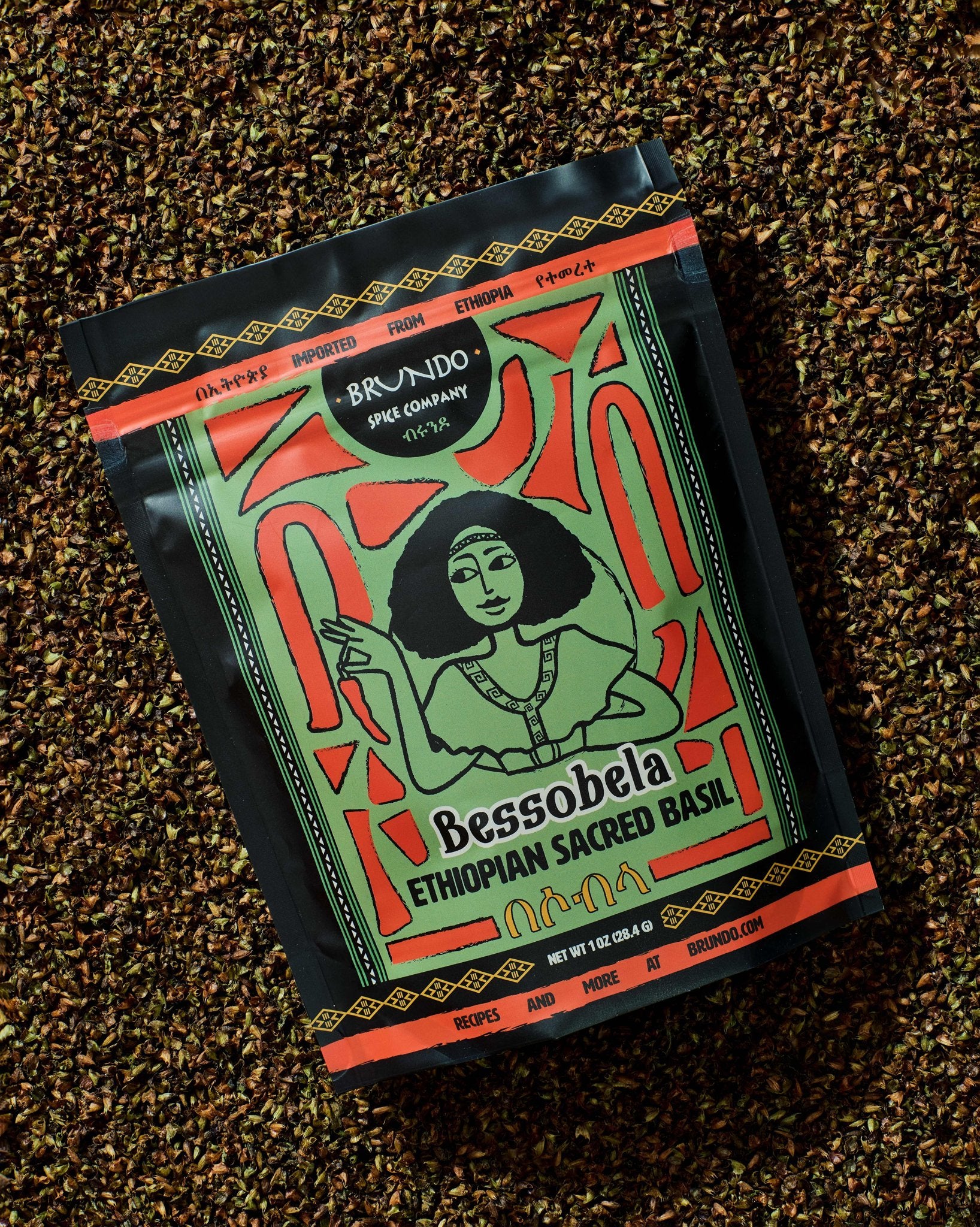 Brundo Spice Company Bessobela Ethiopian Sacred Basil pouch displayed on a bed of dried basil leaves.