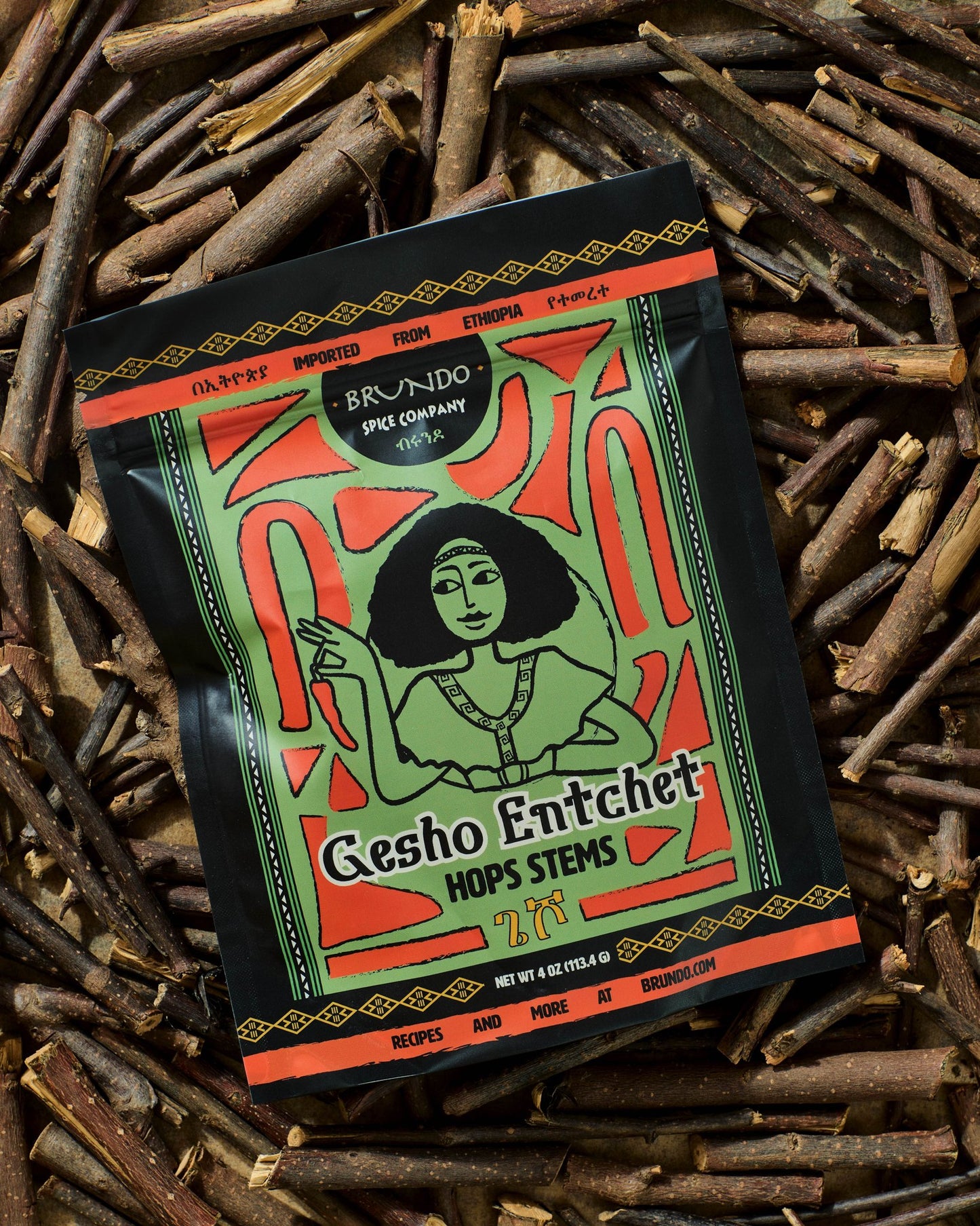 Brundo Spice Company Gesho Entchet Ethiopian hops stems pouch displayed on a bed of dried hop stems.