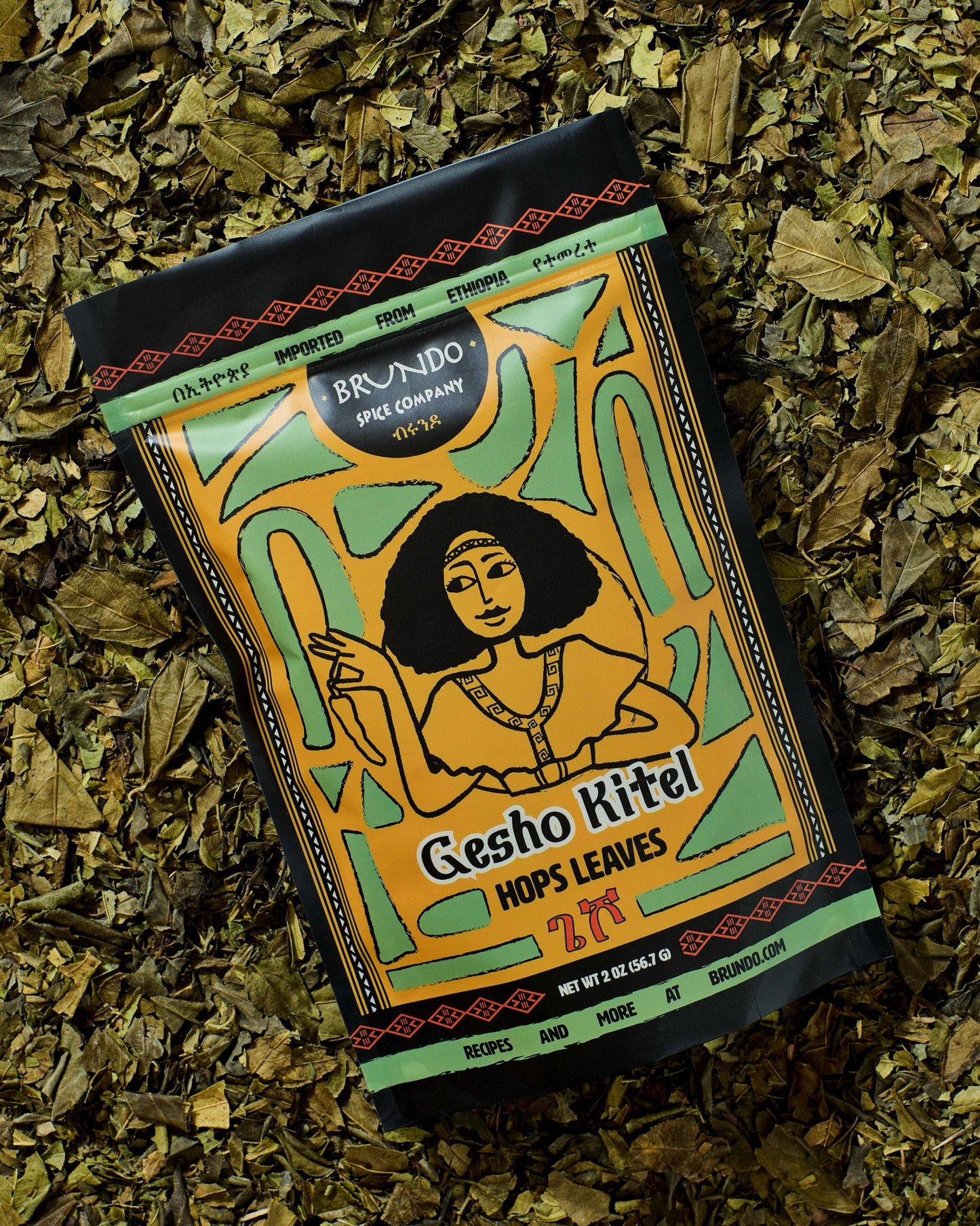 Brundo Spice Company Gesho Kitel Ethiopian hops leaves pouch placed on a bed of dried hops leaves.