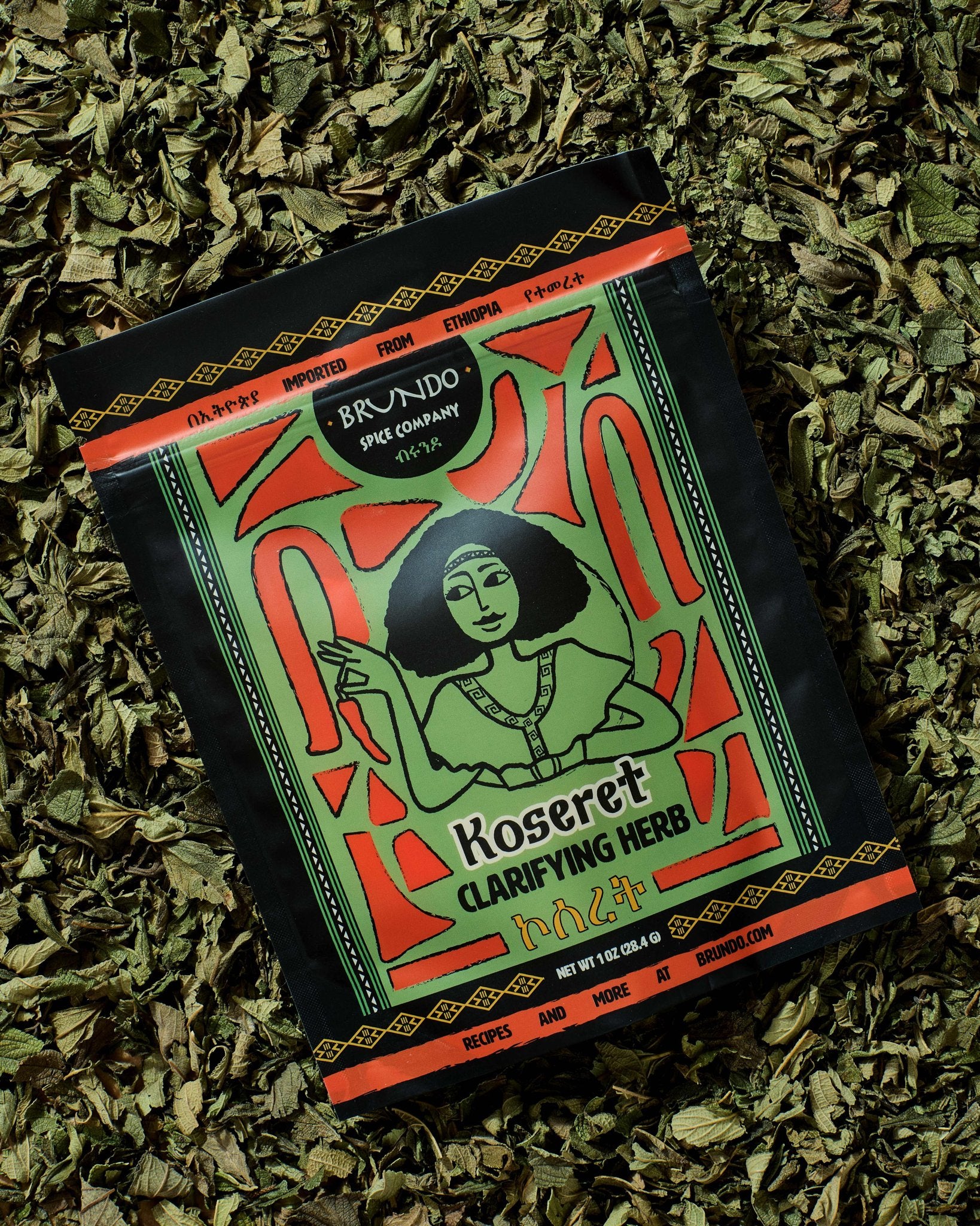 Brundo Spice Company Koseret Clarifying Herb pouch displayed on a bed of dried Ethiopian koseret leaves.