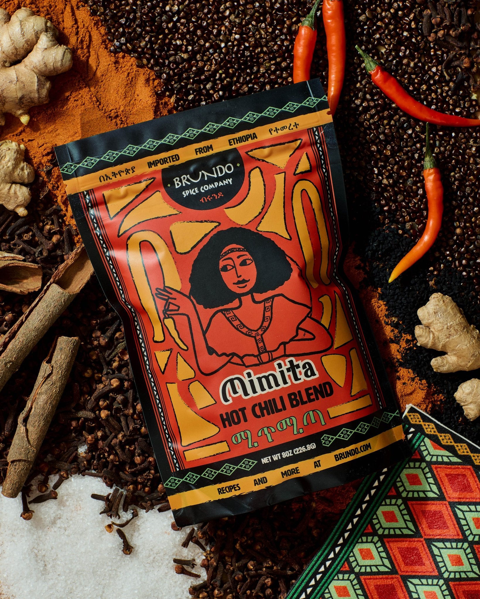 Brundo Spice Company Mimita Hot Chili Blend in a glass spice jar with a gold lid on a white background.