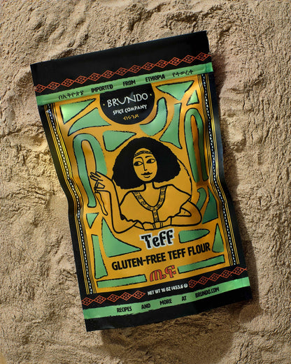 Brundo Spice Company Teff Gluten-Free Teff Flour pouch resting on a smooth bed of fine teff flour.
